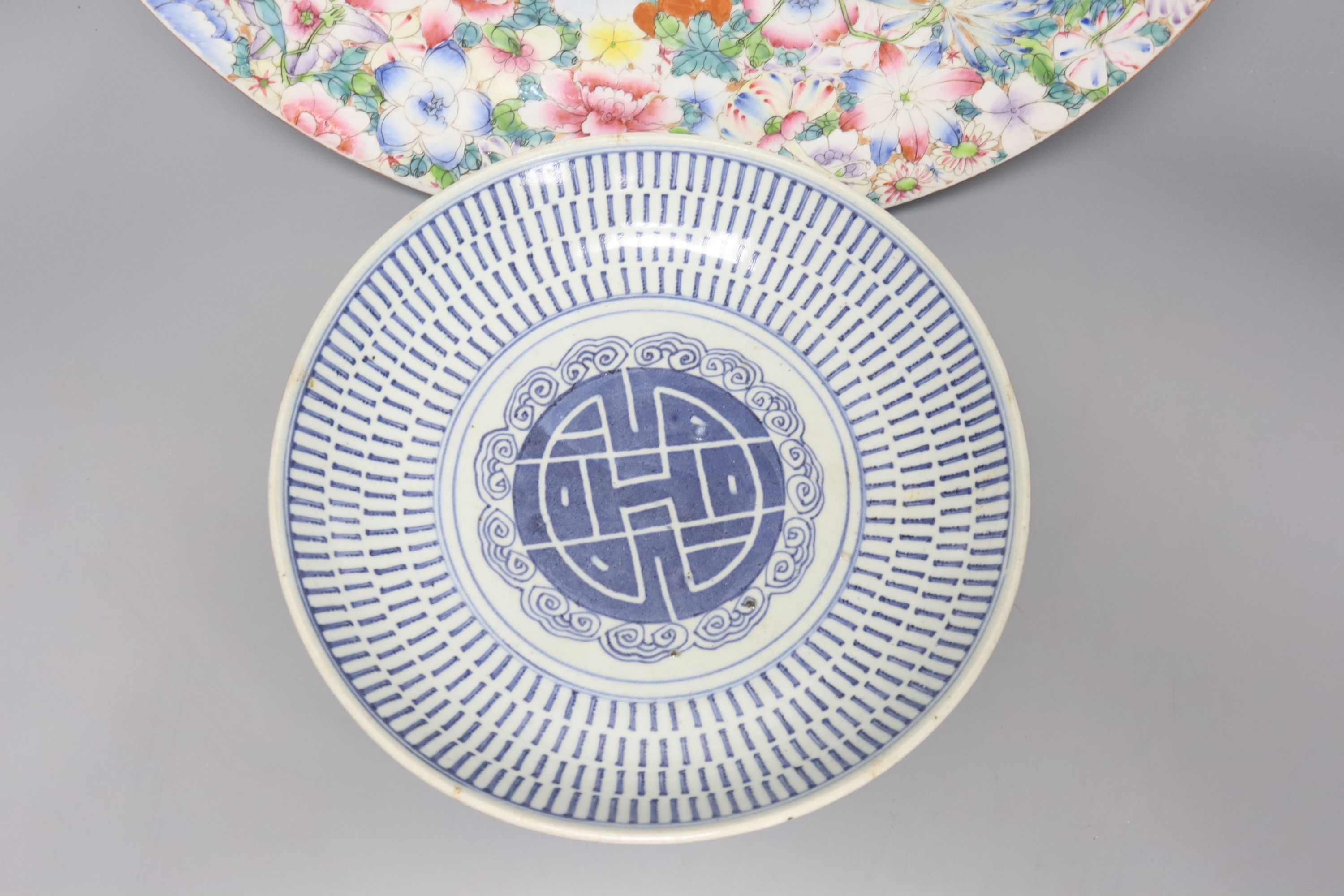 A Chinese thousand flower enamelled porcelain dish, 20th century, 40.5cm, and a mid 19th century Chinese blue and white dish, 26.5cm